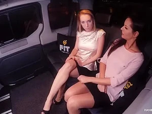 Beautiful European babes fuck each other in the backseat of the car