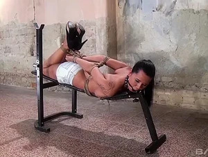 Mia Manarote is bound to a weight bench to give you a fetish show